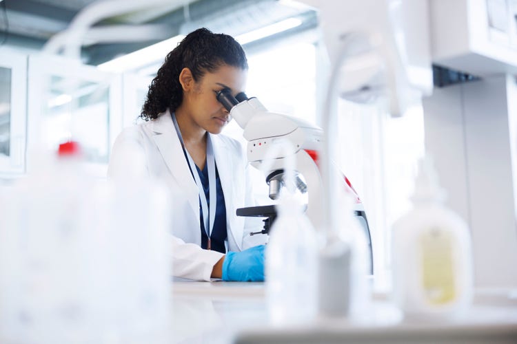 Scientist looking into a microscope